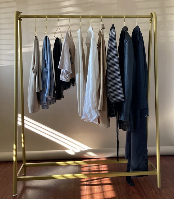 CLOTHES HANGING ON A GOLD RACK